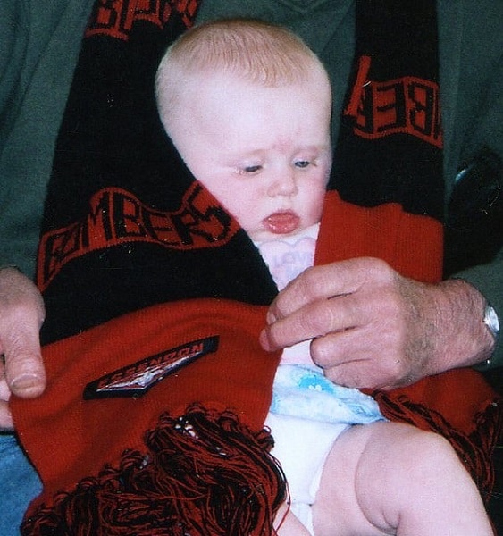 The Footy Scarf (Bombers): Draped around the toddler by her Australian grandfather. She later chose her grandmother’s team instead!
