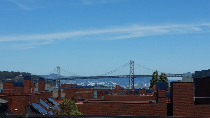 The less-iconic Bay Bridge, linking the city of San Francisco to its eastern neighbors across the Bay. It is a major commuting thoroughfare for justice practitioners, but the underpasses also serve as more permanent homes for the homeless.