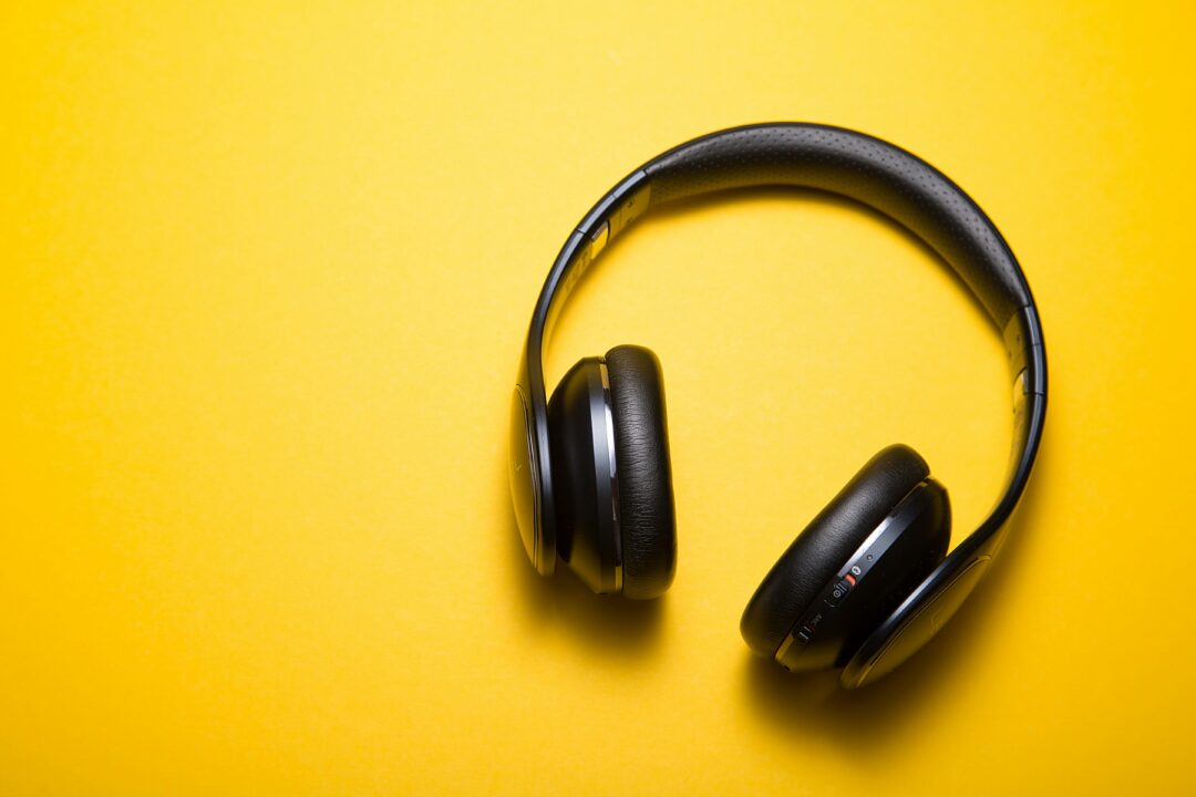 Black Headphones on yellow background.