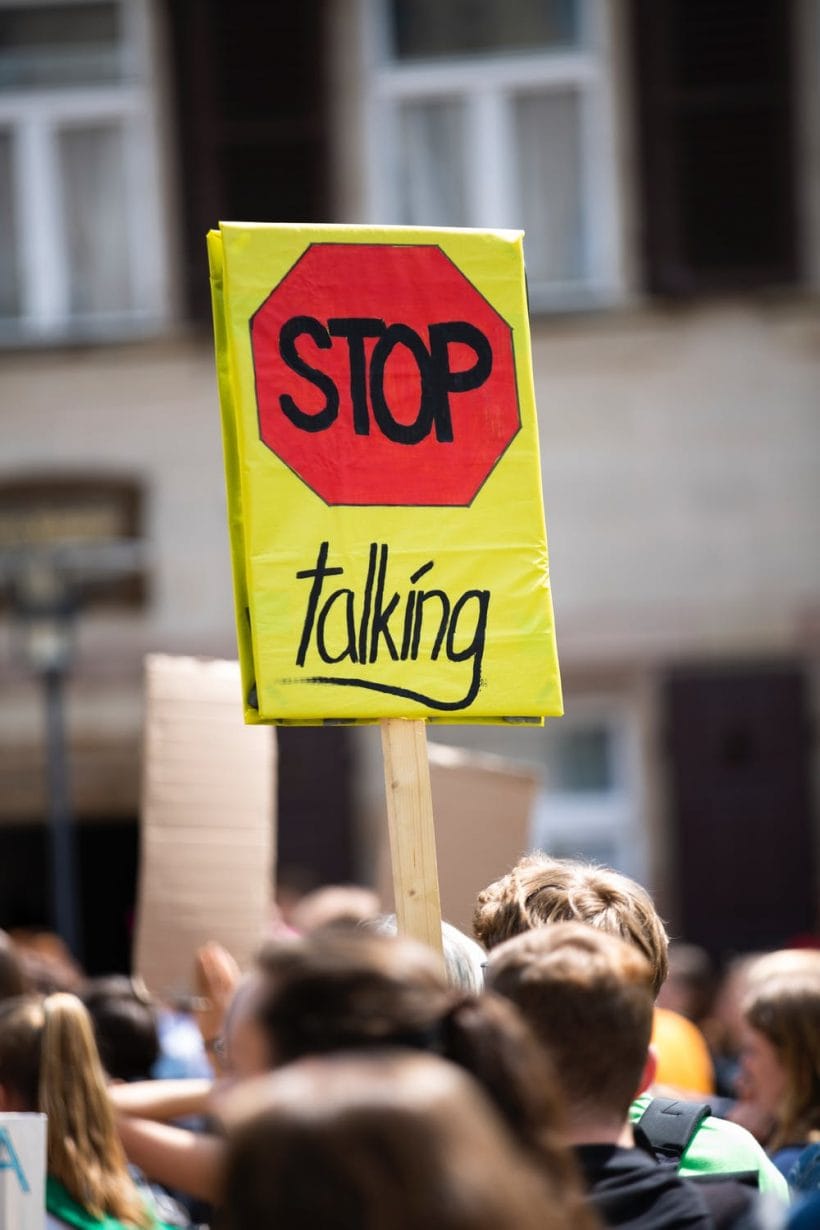 A protest sign that says 'stop talking'