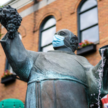 A statue with a facemask