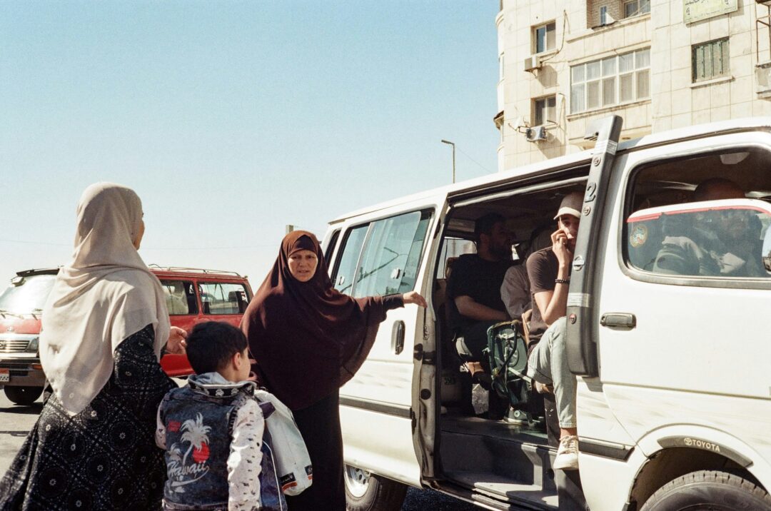 A group of people boarding a collective taxi